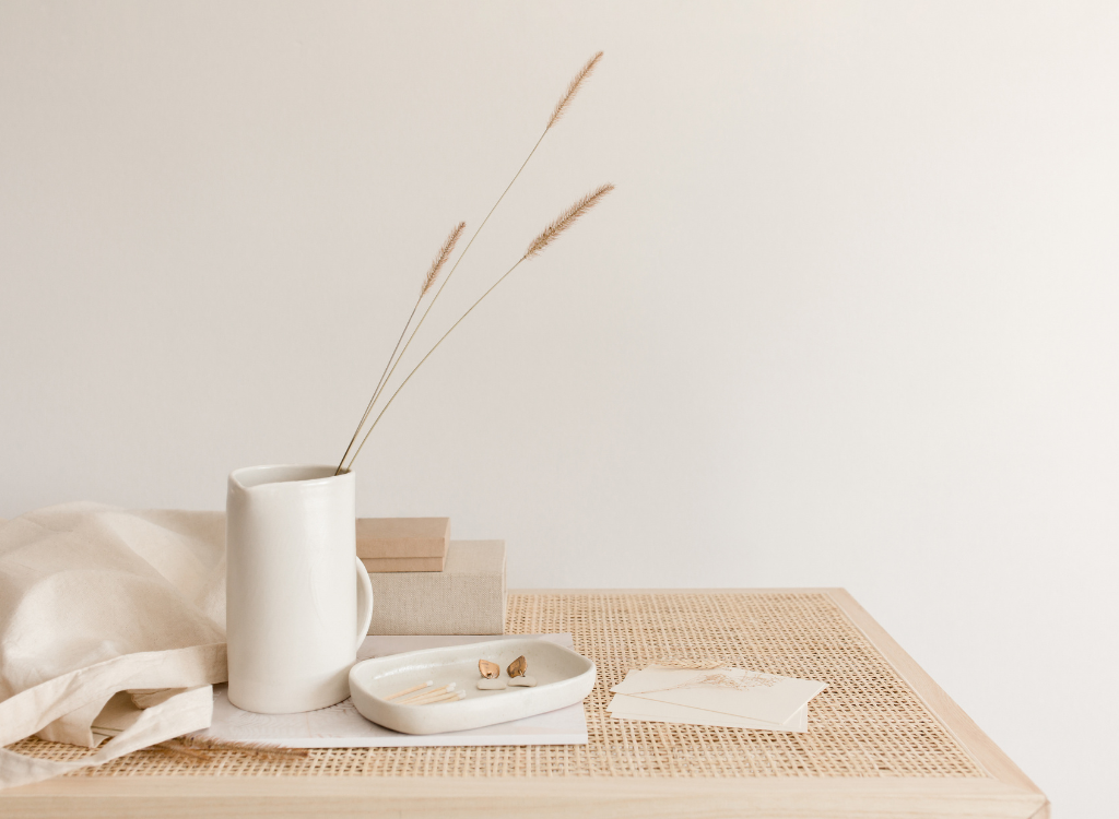 Desk of a creative business owner, with ceramics and dried flowers.