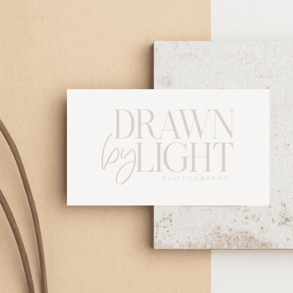 Business card on decorative background showing primary logo for wedding photographer