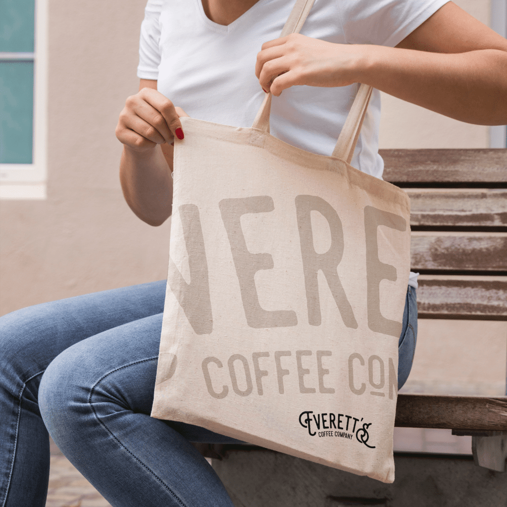 Branding for Everetts coffeee company on the side of a canvas tote bag with their log in the corner of the bag
