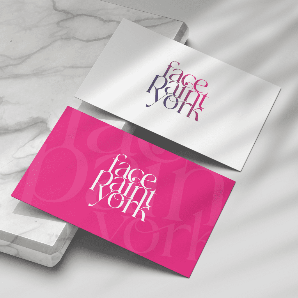 Business cards showing logo design for Face Paint York, on bright pink card and white card