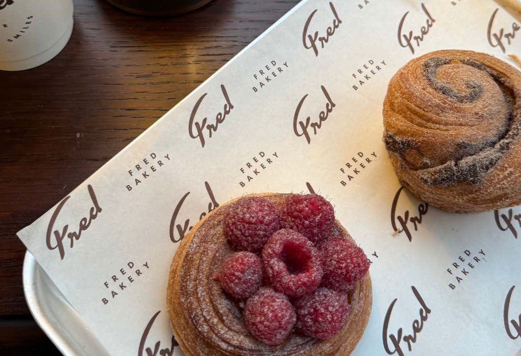 2 pastries on top of paper with the bakery logo and branding printed on it.