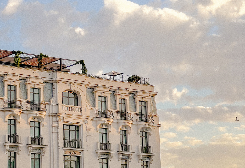 Cloudy skyline with the top of an elegant hotel showing