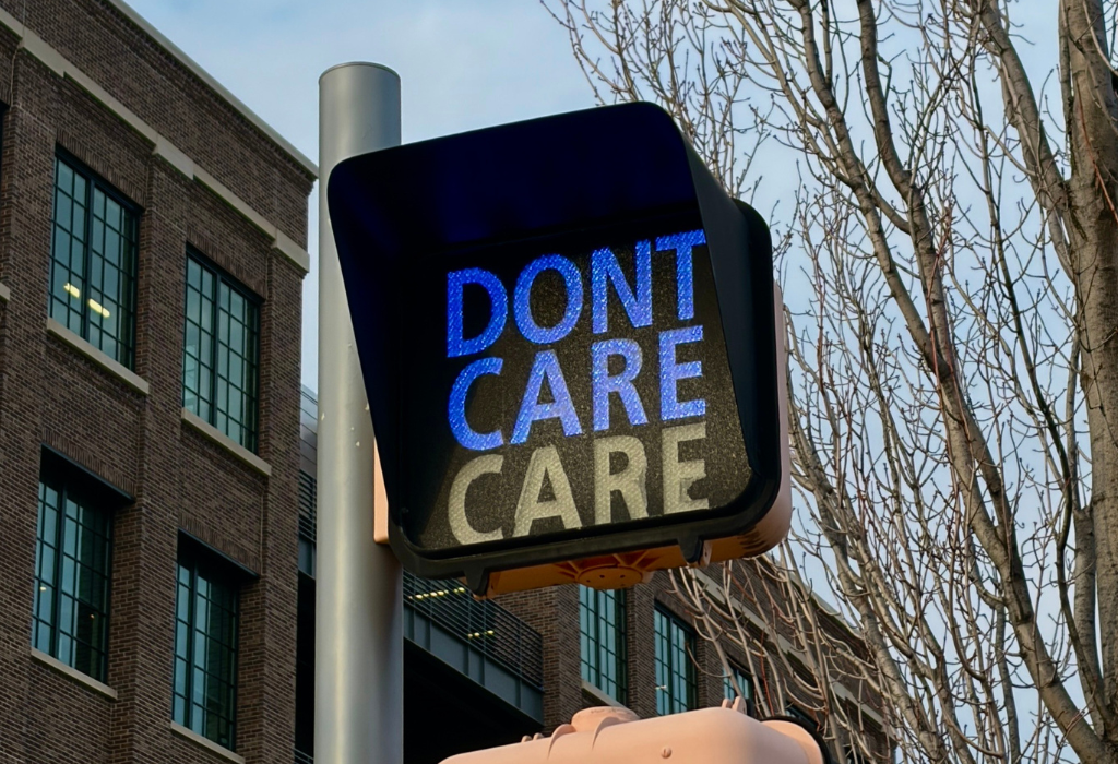 Street sign showing Don't care/care. Why your brand isn't attracting the right clients